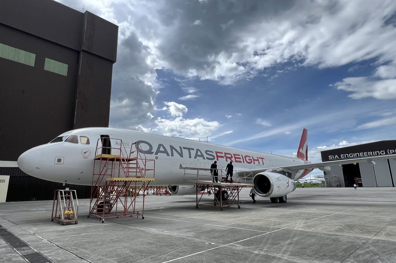 Aircraft nose-on in the hangar under lights