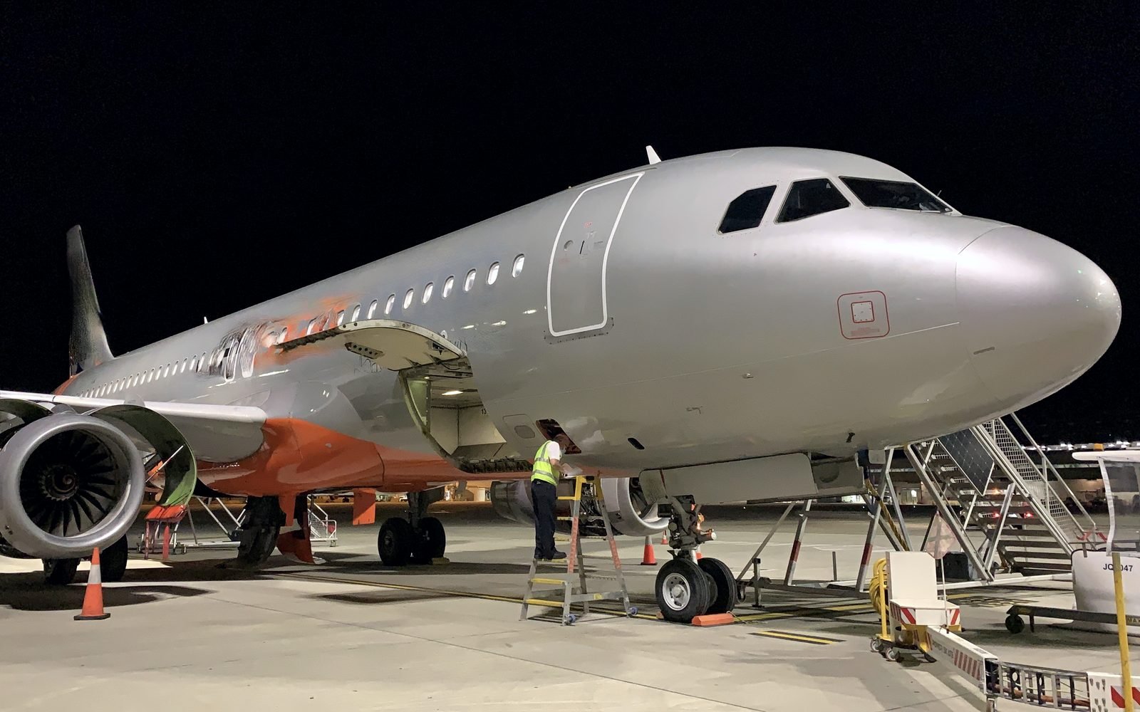 Narrowbody aircraft on the apron at night during a pre-purchase inspection
