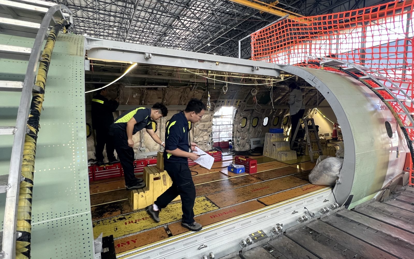 Engineers at the new cargo door opening during an A321 passenger to freighter conversion